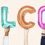 Diverse hands hold up multi-colored balloon letters that say WELCOME